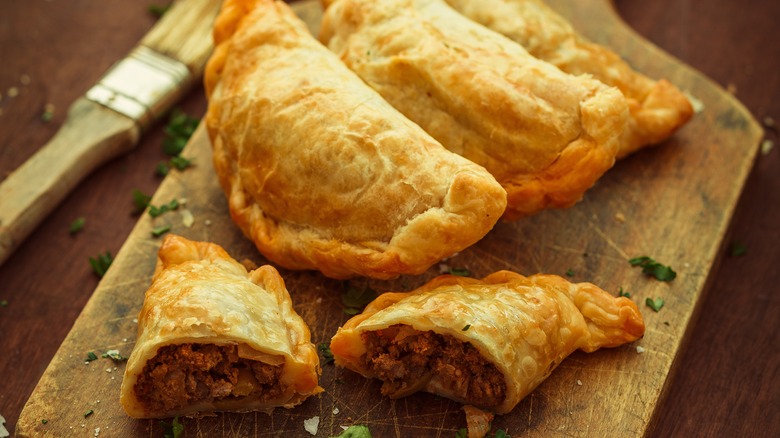 meat pies on chopping board