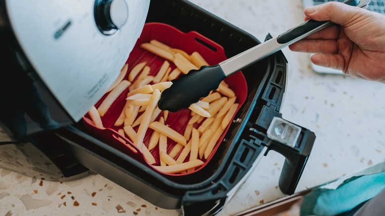 Tongs and fries in air fryer