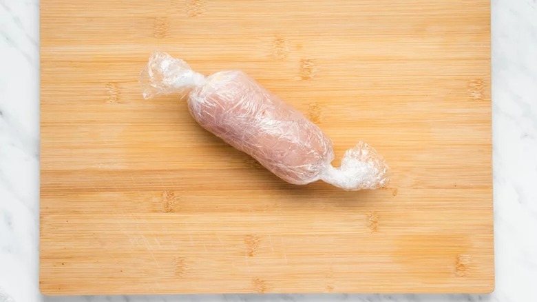 Chicken cordon bleu in plastic wrap