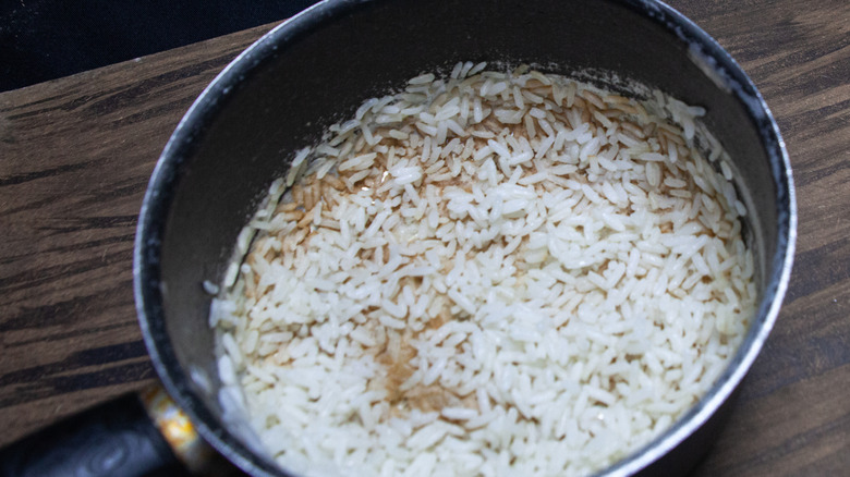 pan with layer of burnt rice at bottom