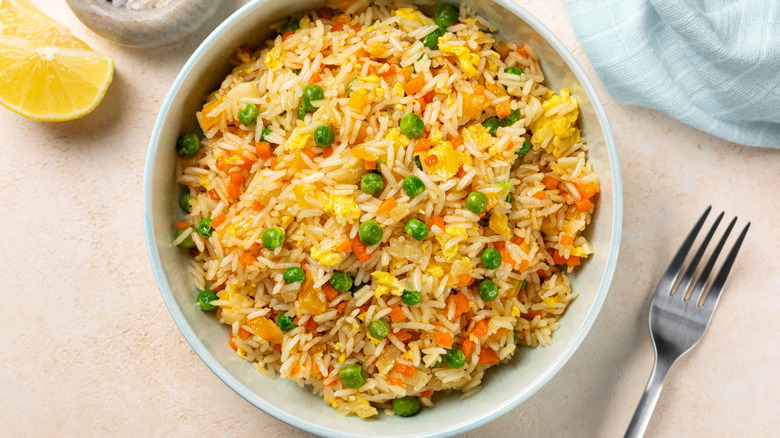 bowl of egg fried rice with peas and carrots