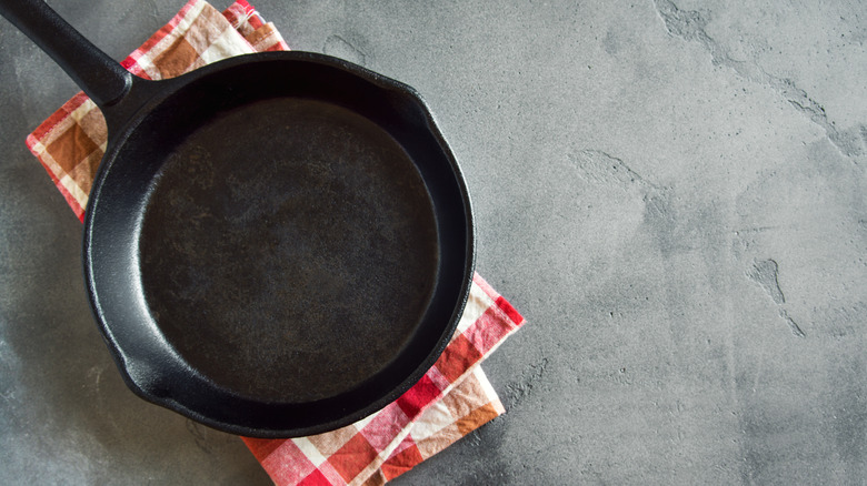 Cast iron pan with checkered towel