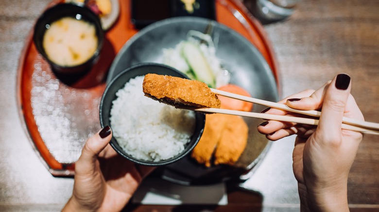 Overview of hands eating tonkatsu