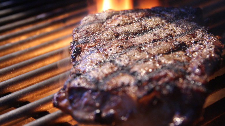 A seasoned steak on a grill