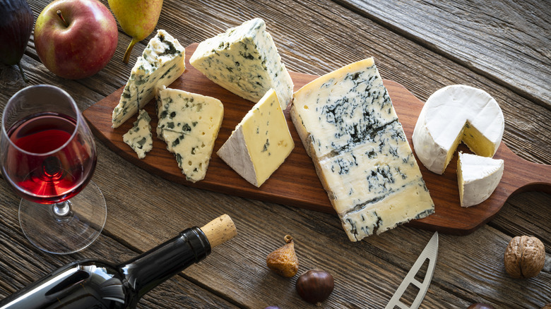 French cheese board beside a glass of red wine