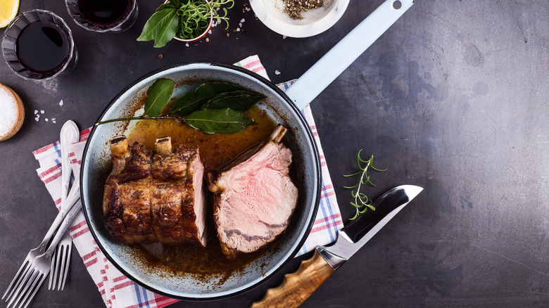Aerial view of prime rib in a pot with drippings