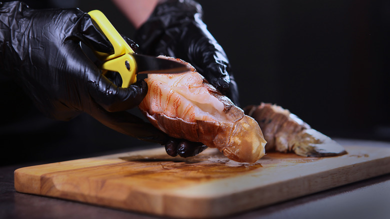 chef removing lobster tail shell