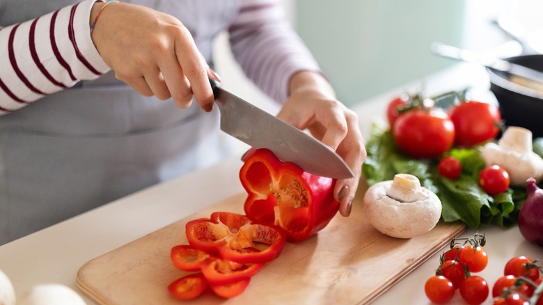 person chopping bell pepper