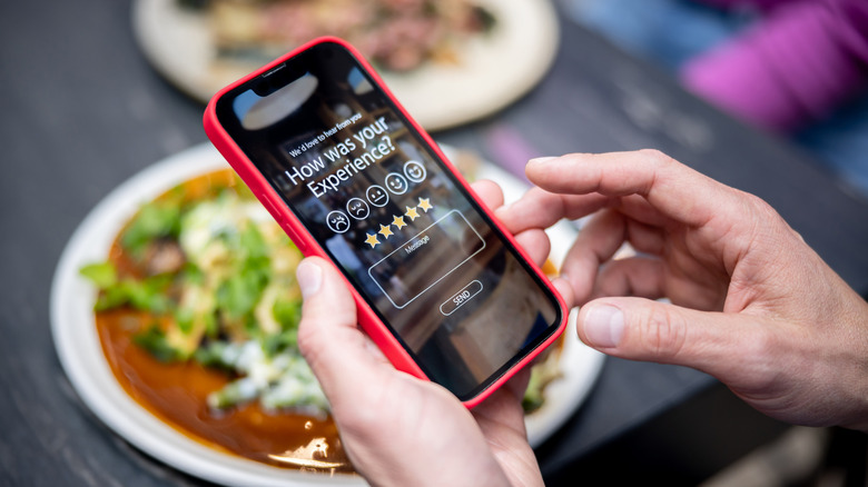 Phone showing customer leaving review
