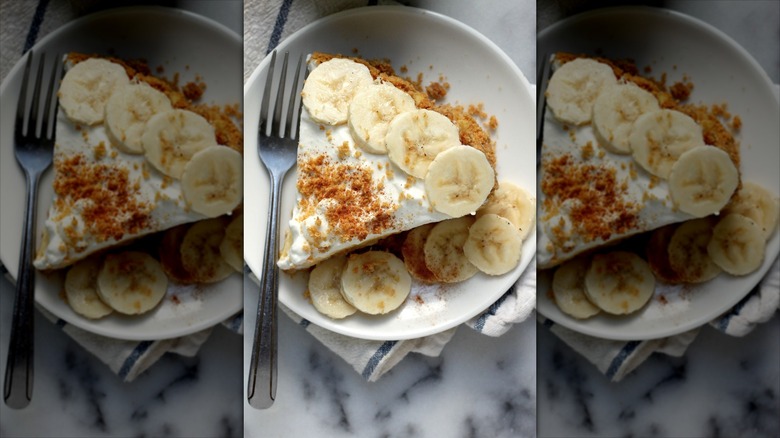 Close up of a slice of banana cream pie with a fork