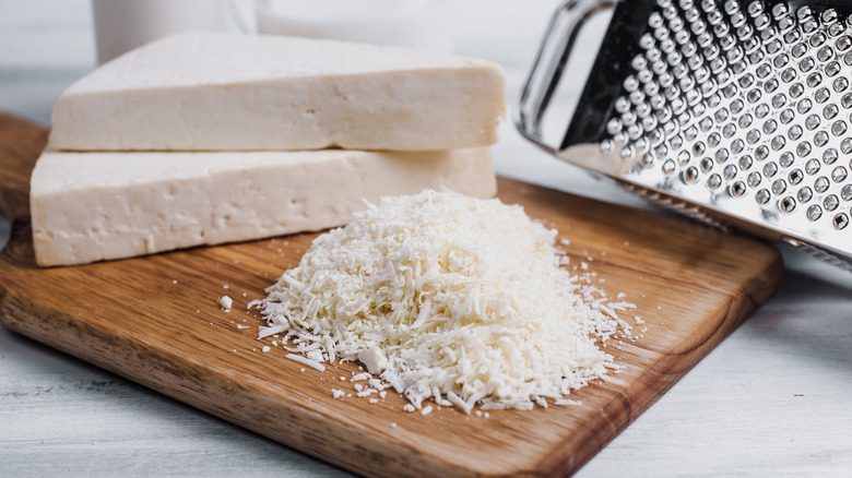 A block and a pile of shredded cotija cheese