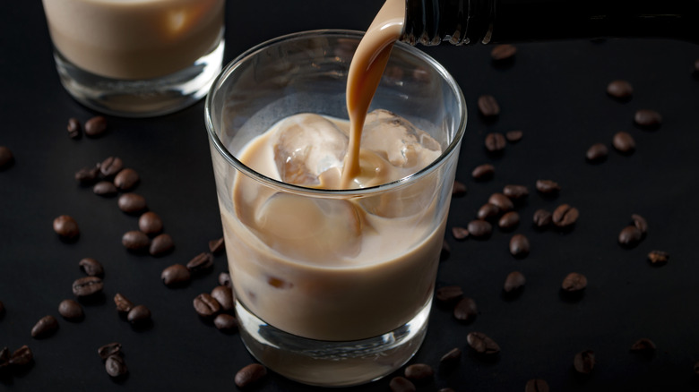 Pouring cream liqueur into glass