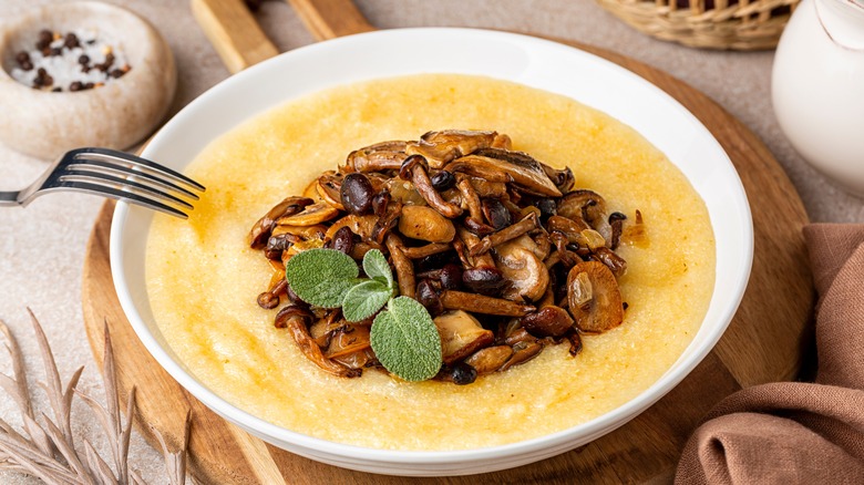 Polenta and mushrooms in white bowl