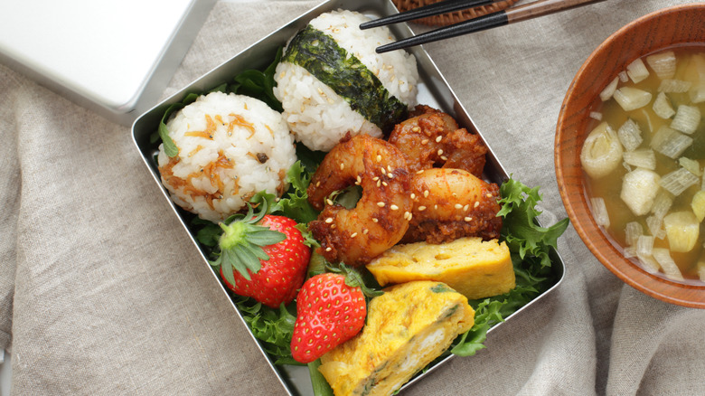 A Japanese bento lunch box on tablecloth