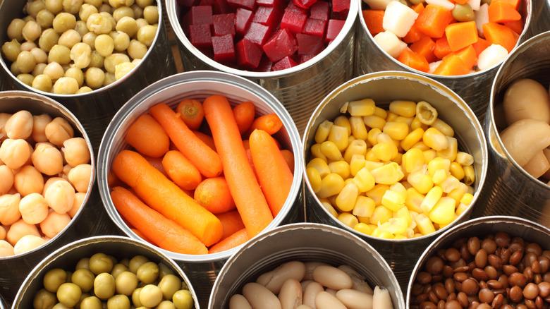 overhead view of open cans of beets, carrots, corn, peas, and carrots