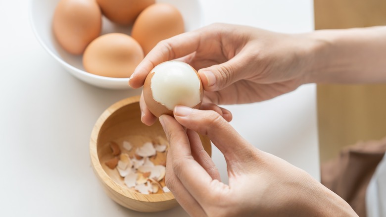 person boiling an egg