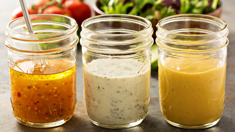 3 homemade salad dressings in glass jars