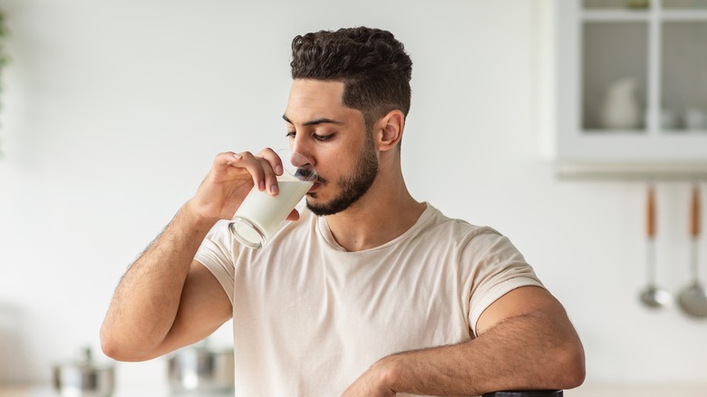 man tasting milk