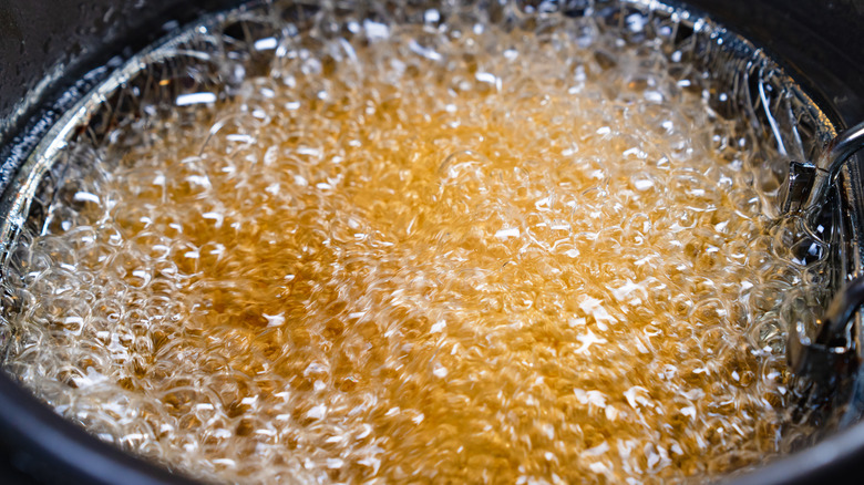 Close up of oil bubbling in pot