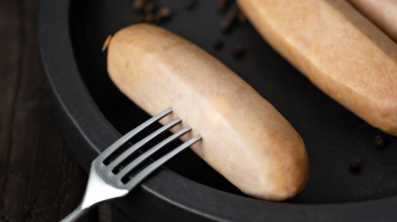 Testing sausages with a fork