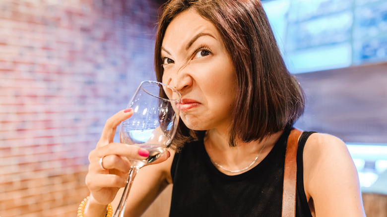 Smelling bad wine from glass