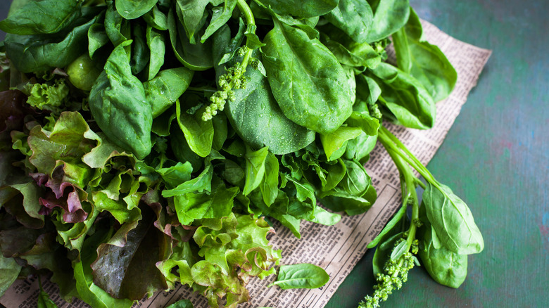 various salad greens on wooden