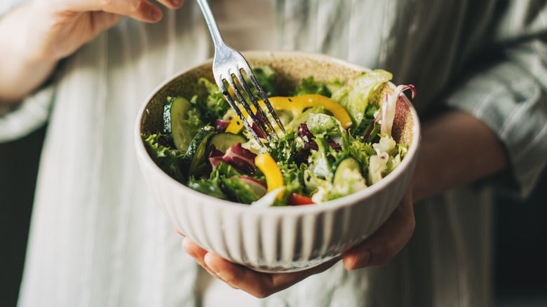 woman holding salad bowl