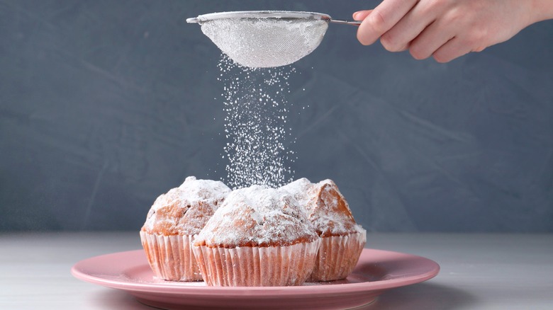 powdered sugar dusting over muffins