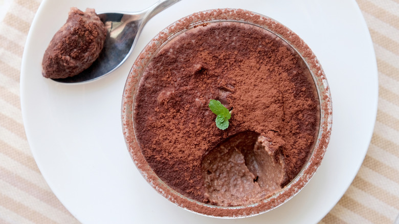 Chocolate mousse in bowl with mint sprig