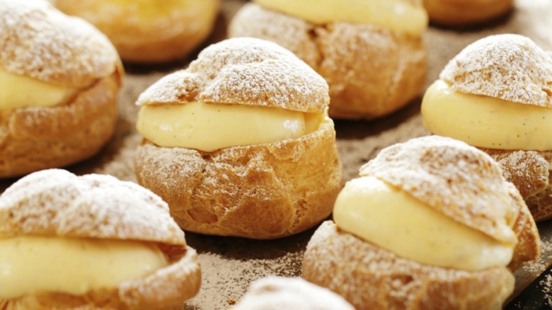 Close-up of many cream puffs stuffed with pastry cream