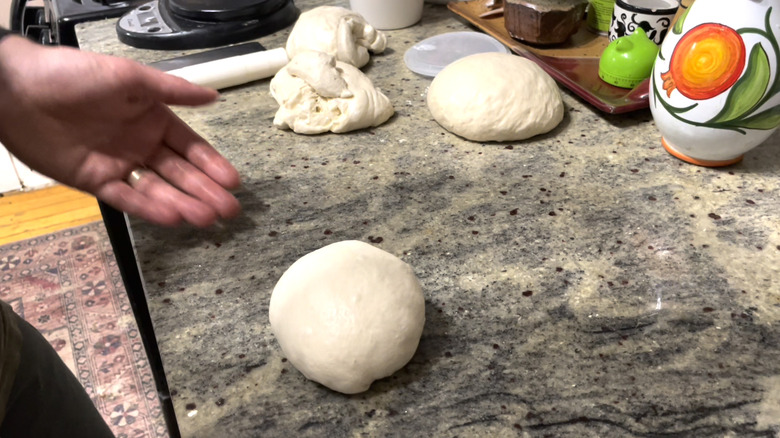 Hand gathering dough ball