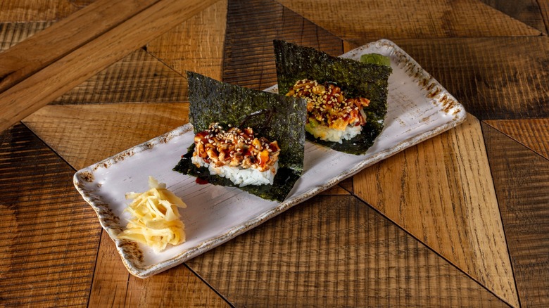 seaweed sheet topped with rice and salmon