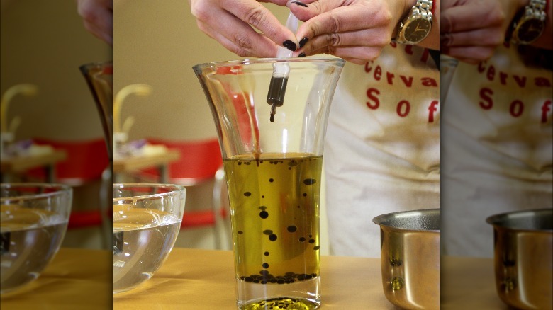 making agar pearls with a syringe and three containers of liquid