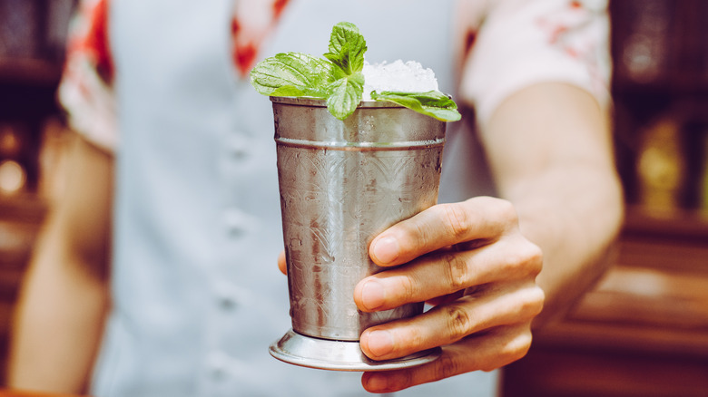 Hand holding mint julep