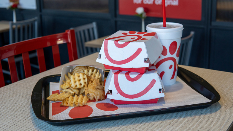 tray of sandwich boxes, fries, and a drink at Chick-fil-A