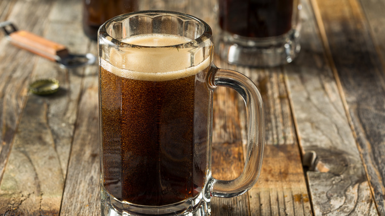 Mug of root beer on wood table