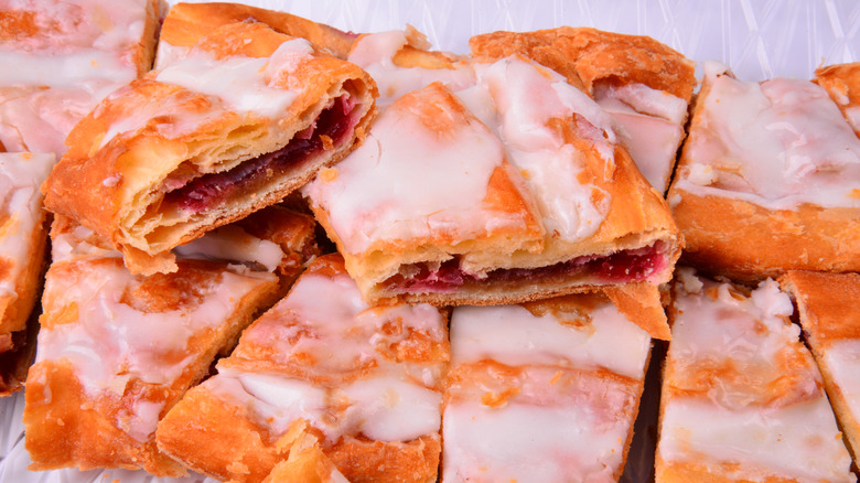 Sliced up raspberry kringle with icing