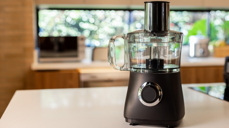 A clean black food processor on a kitchen counter