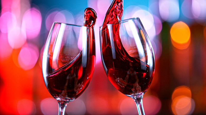 toasting red wine in glasses