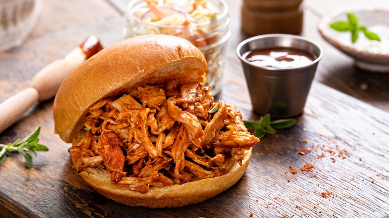 Pulled pork sandwich with sauce on the side 