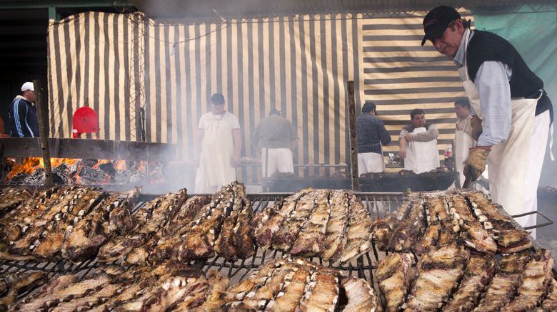 man preparing traditional asado