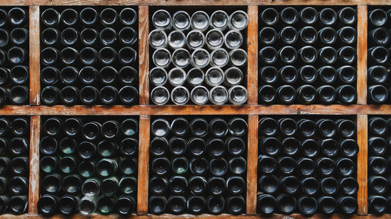 wine bottles stored on their side in a cellar