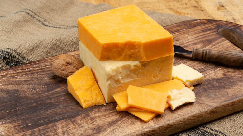 Array of different Wisconsin cheeses on a wooden board