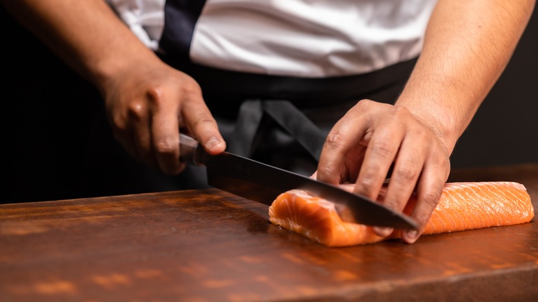 Close-up of chef slicing sushi fish