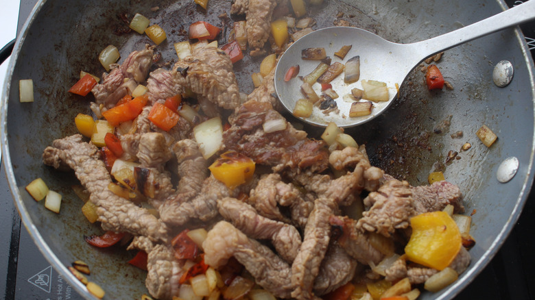 Onions and peppers in pan