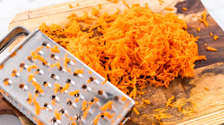 box grater with carrots shreddings