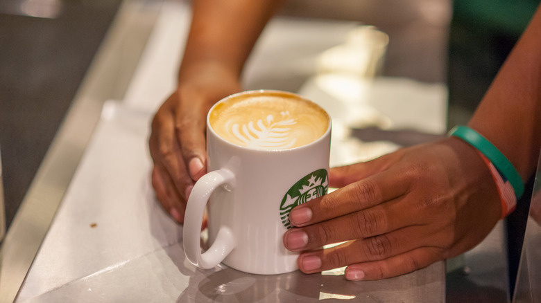 Mug of coffee with barista