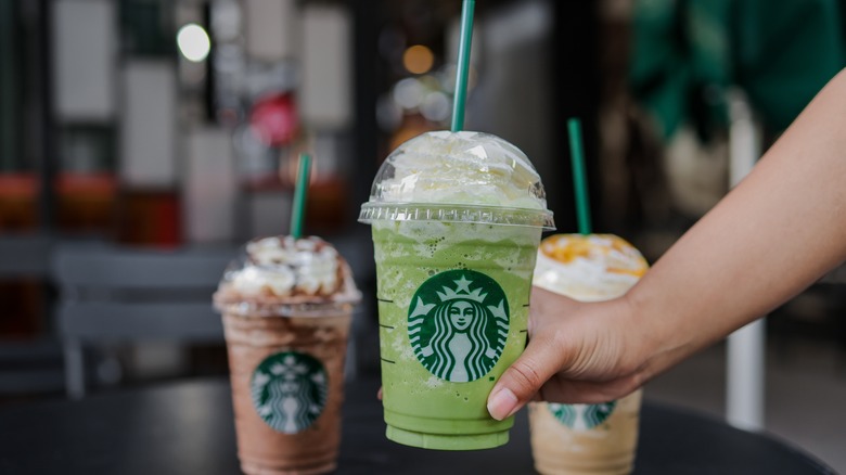 A hand holding a Frappuccino