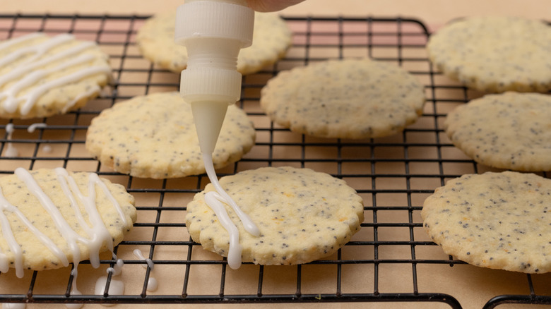 Icing lemon poppy seed cookies with squeeze bottle