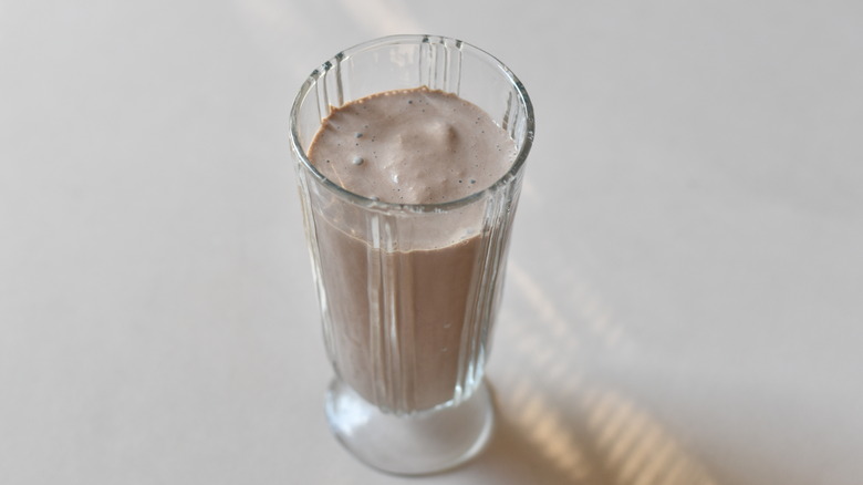 chocolate milkshake in tall glass